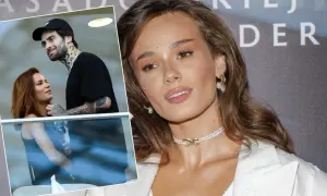 Natalia Szroeder z partnerem, uśmiechnięci i blisko siebie. W tle widać fragmenty napisu.