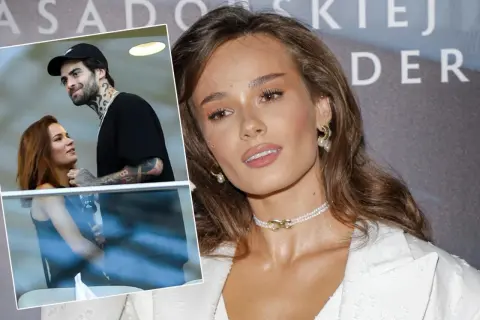 Natalia Szroeder z partnerem, uśmiechnięci i blisko siebie. W tle widać fragmenty napisu.